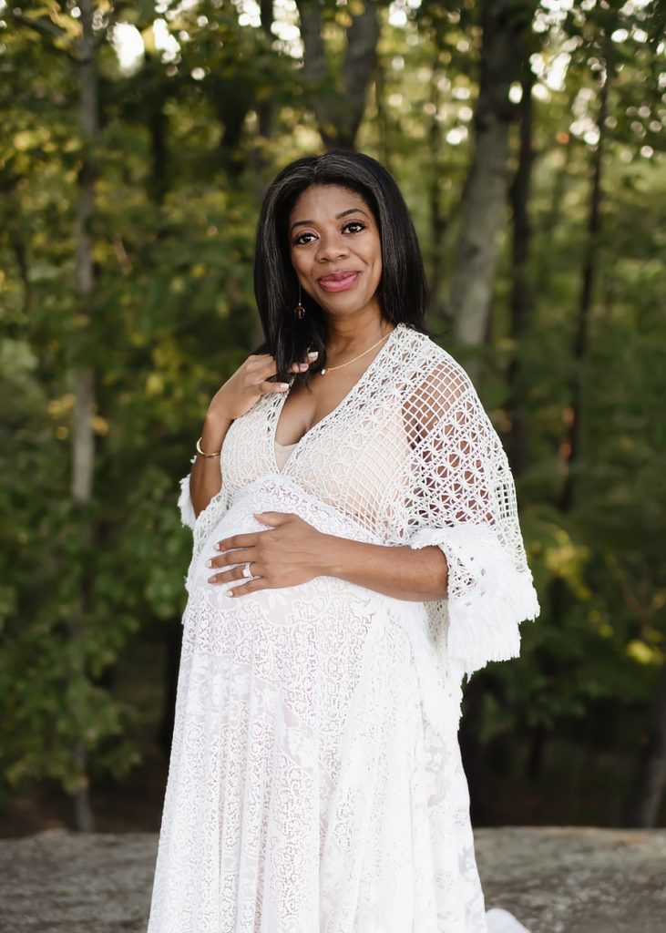 A soon to be mom poses for her maternity photographer