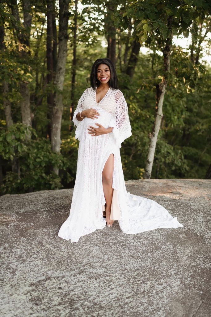 A beautiful maternity client wearing a gown form the Iris & Embers client closet